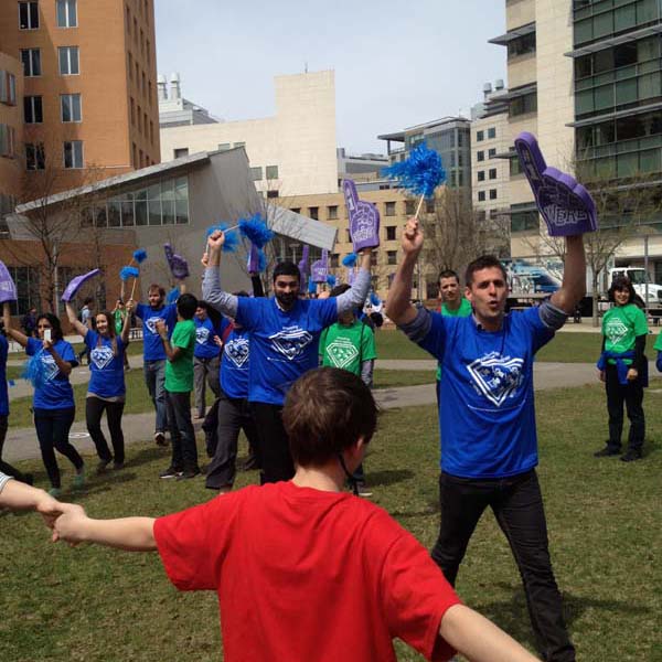 People in blue shirts wave foam fingers