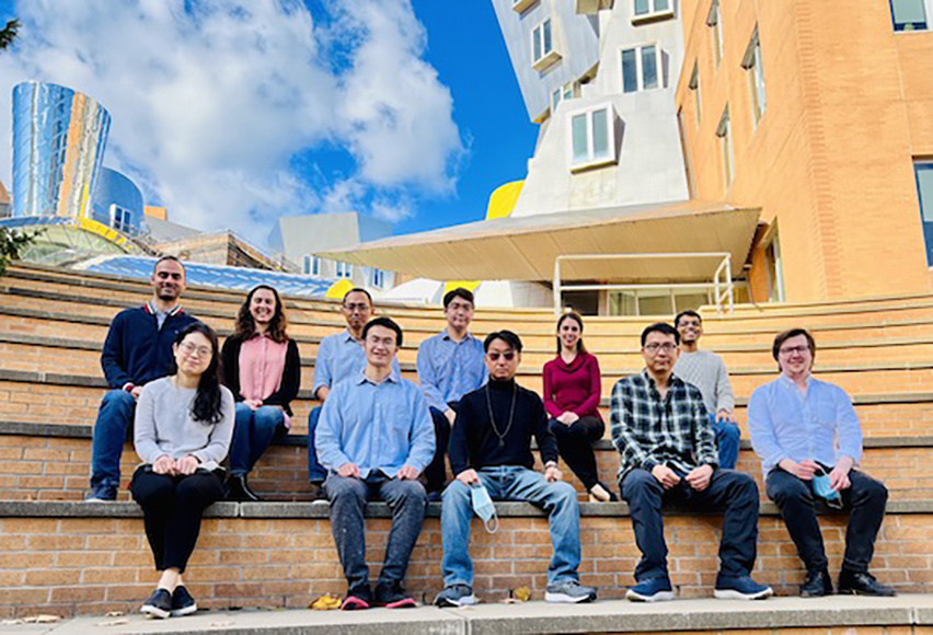 convergence scholars sitting on the steps of the Stata building