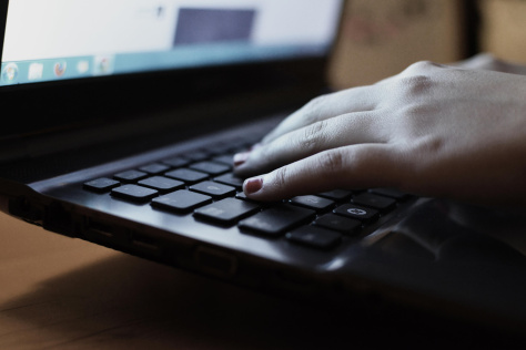 Hands on a laptop keyboard