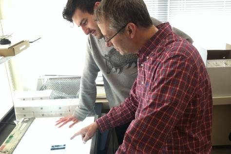 Matt Vander Heiden and a trainee discuss an image on a lightbox